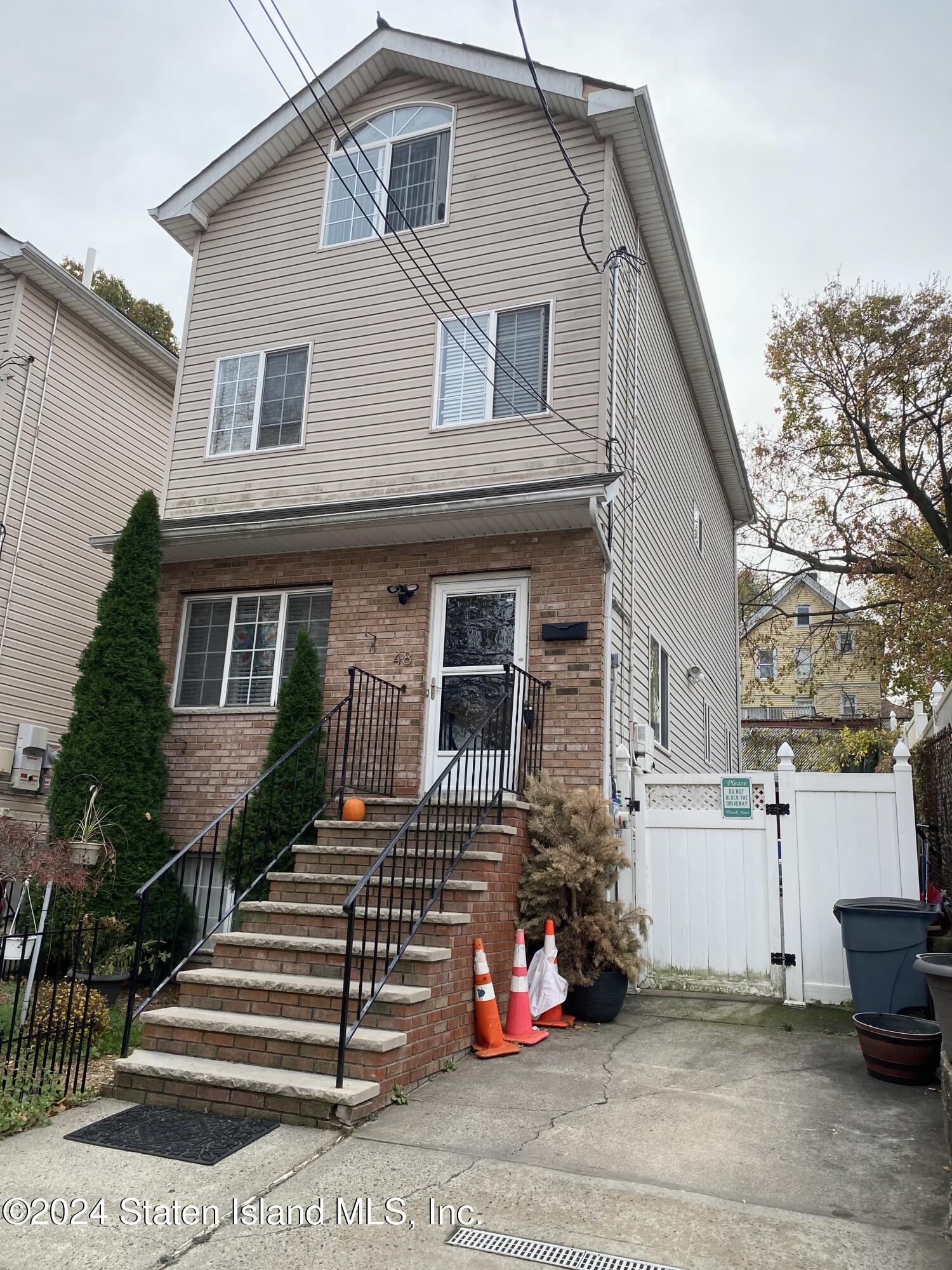 a front view of a house with stairs