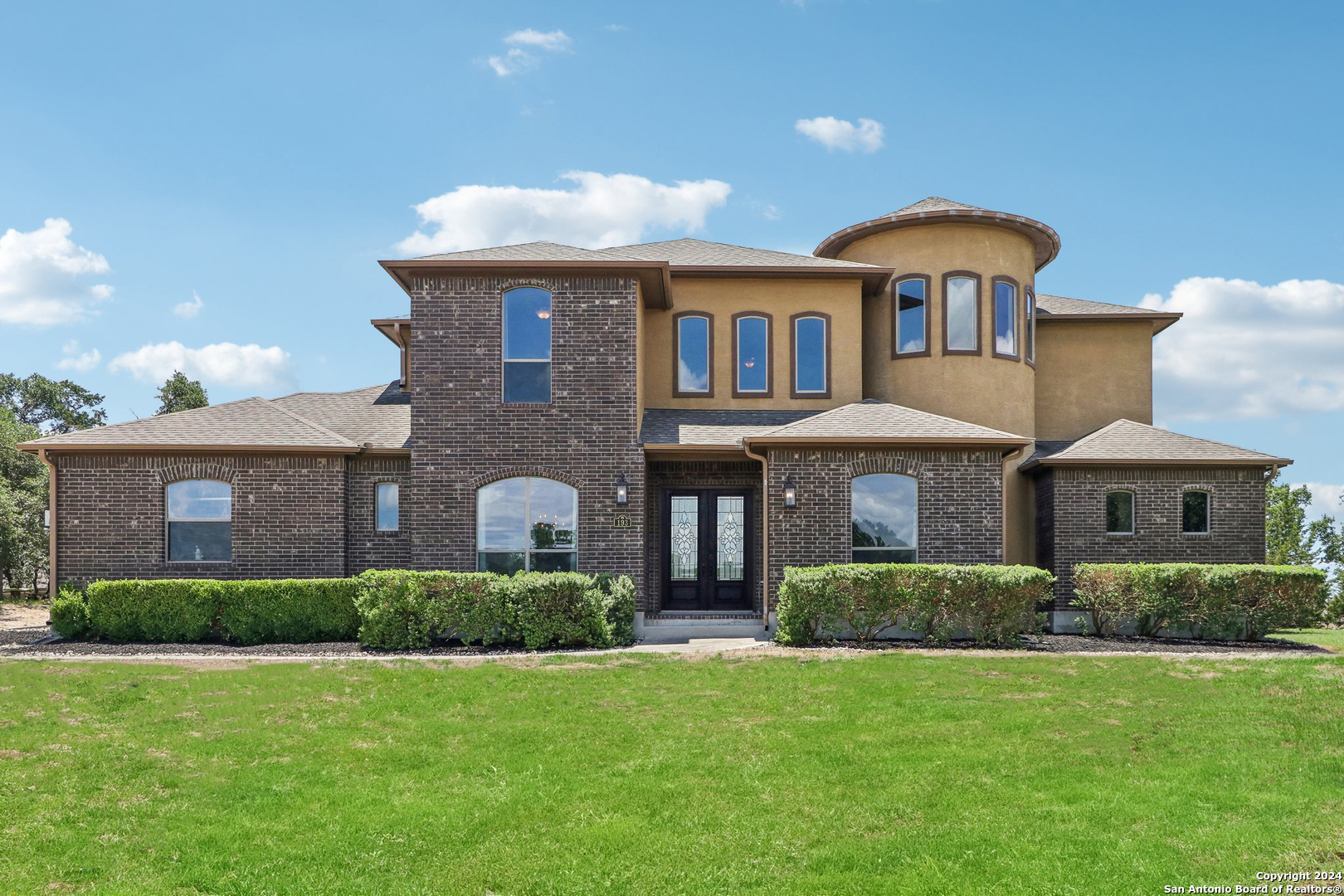 a front view of a house with a yard