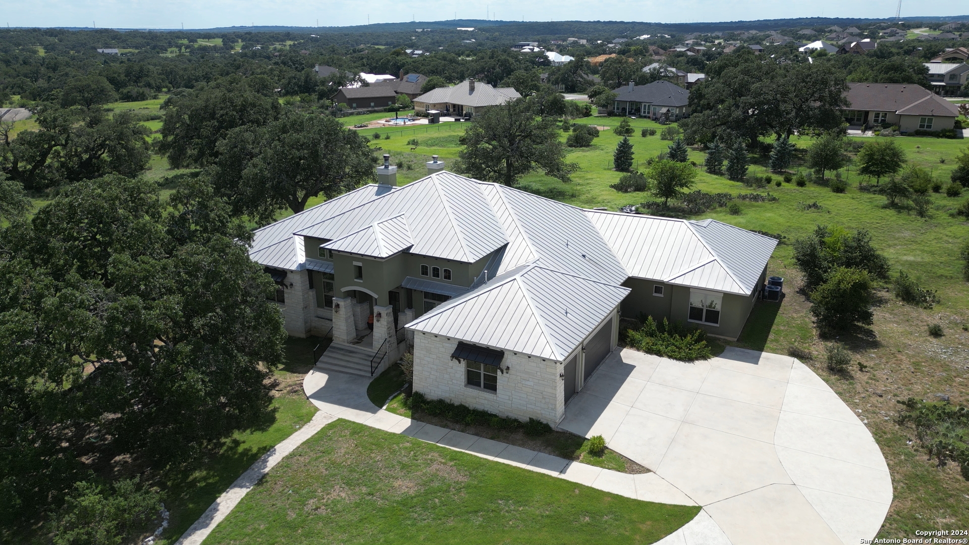 an aerial view of a house with a yard