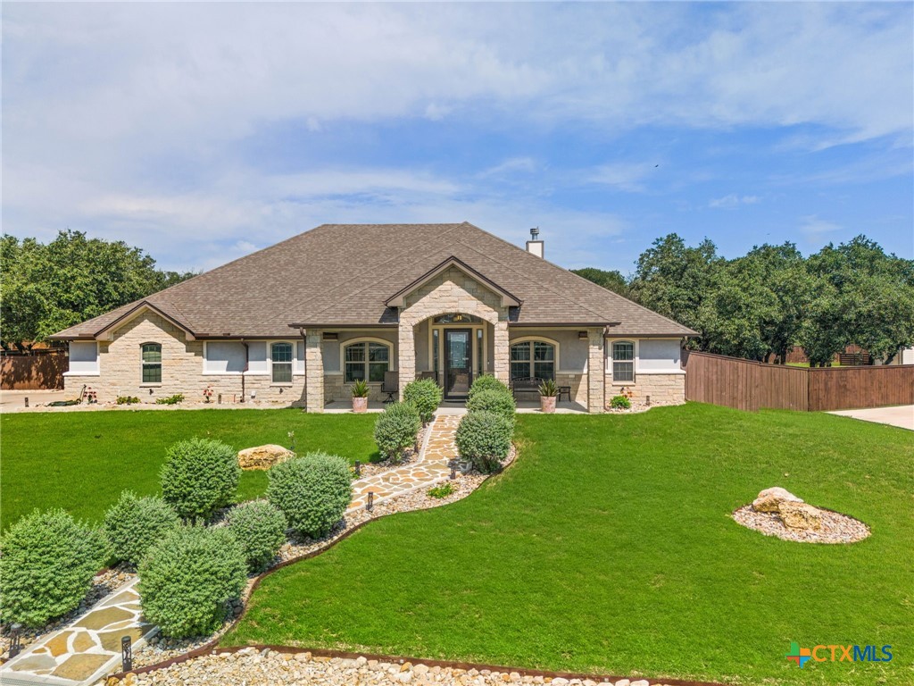 a front view of a house with garden