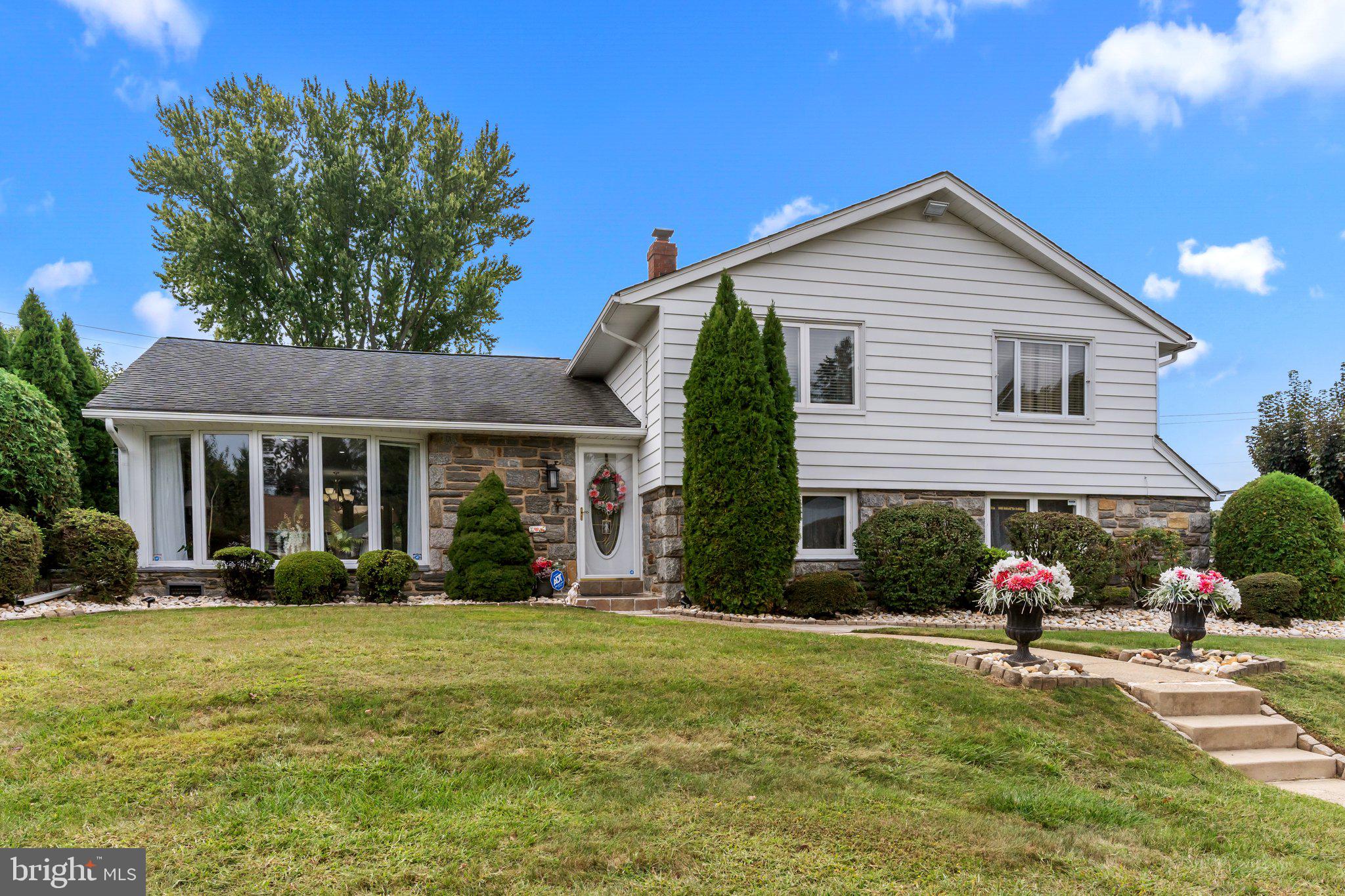 a front view of a house with garden