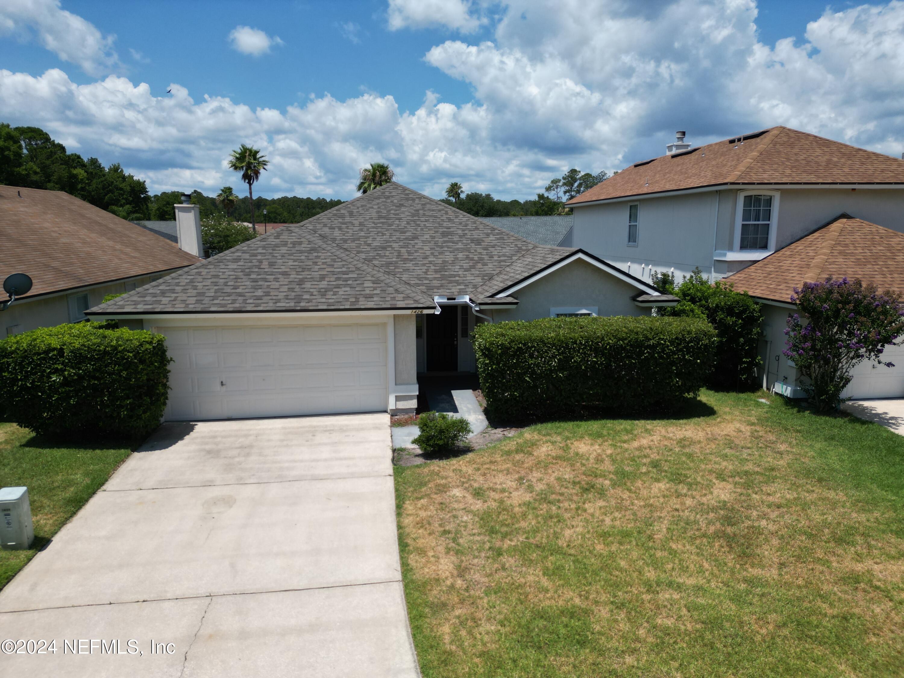 a front view of a house with a yard and garage