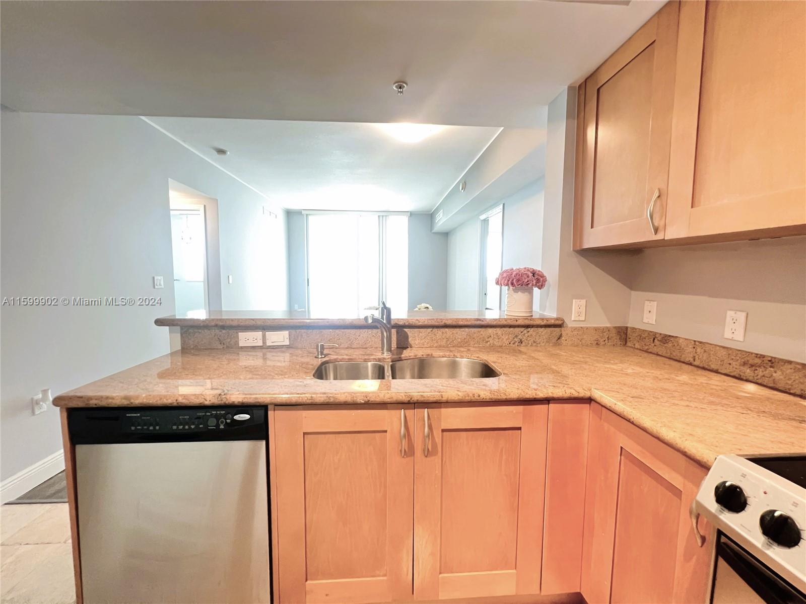 a kitchen with stainless steel appliances granite countertop a sink and a cabinets