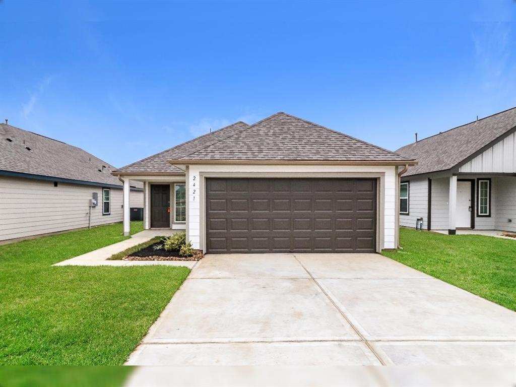 a front view of a house with a yard and garage