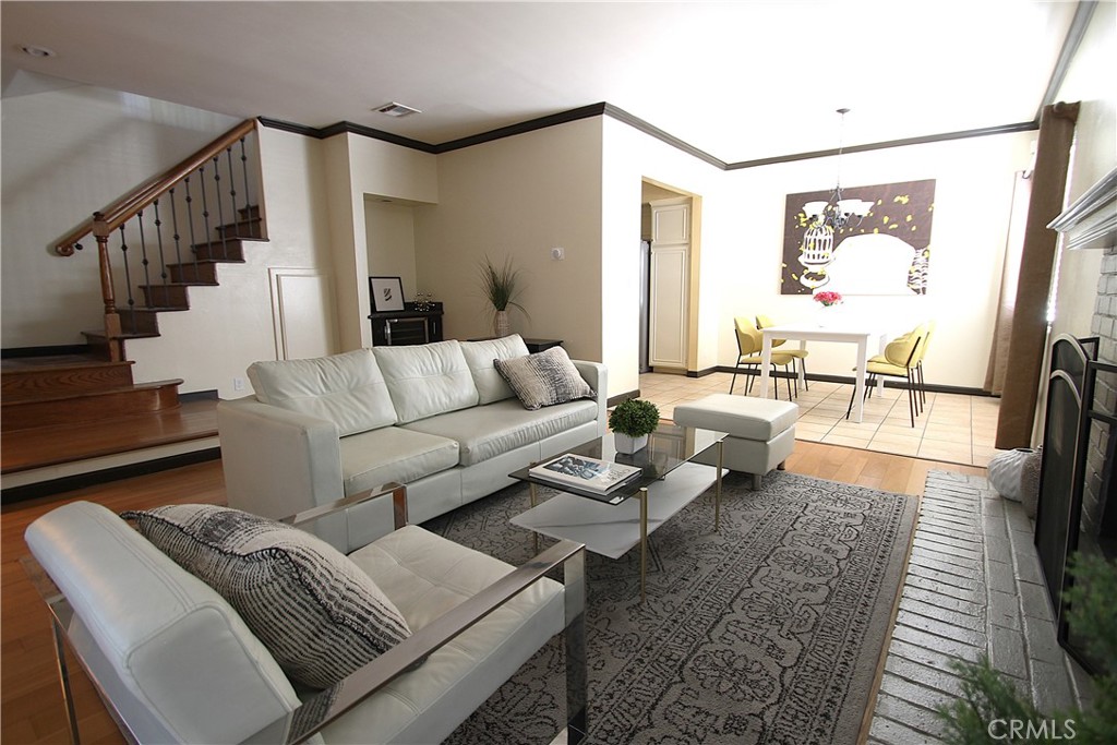 a living room with furniture wooden floor and a table