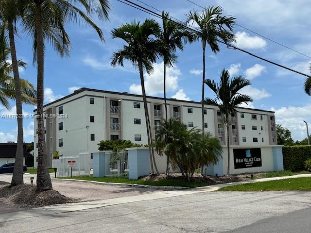 a view of a palm trees in front of a building