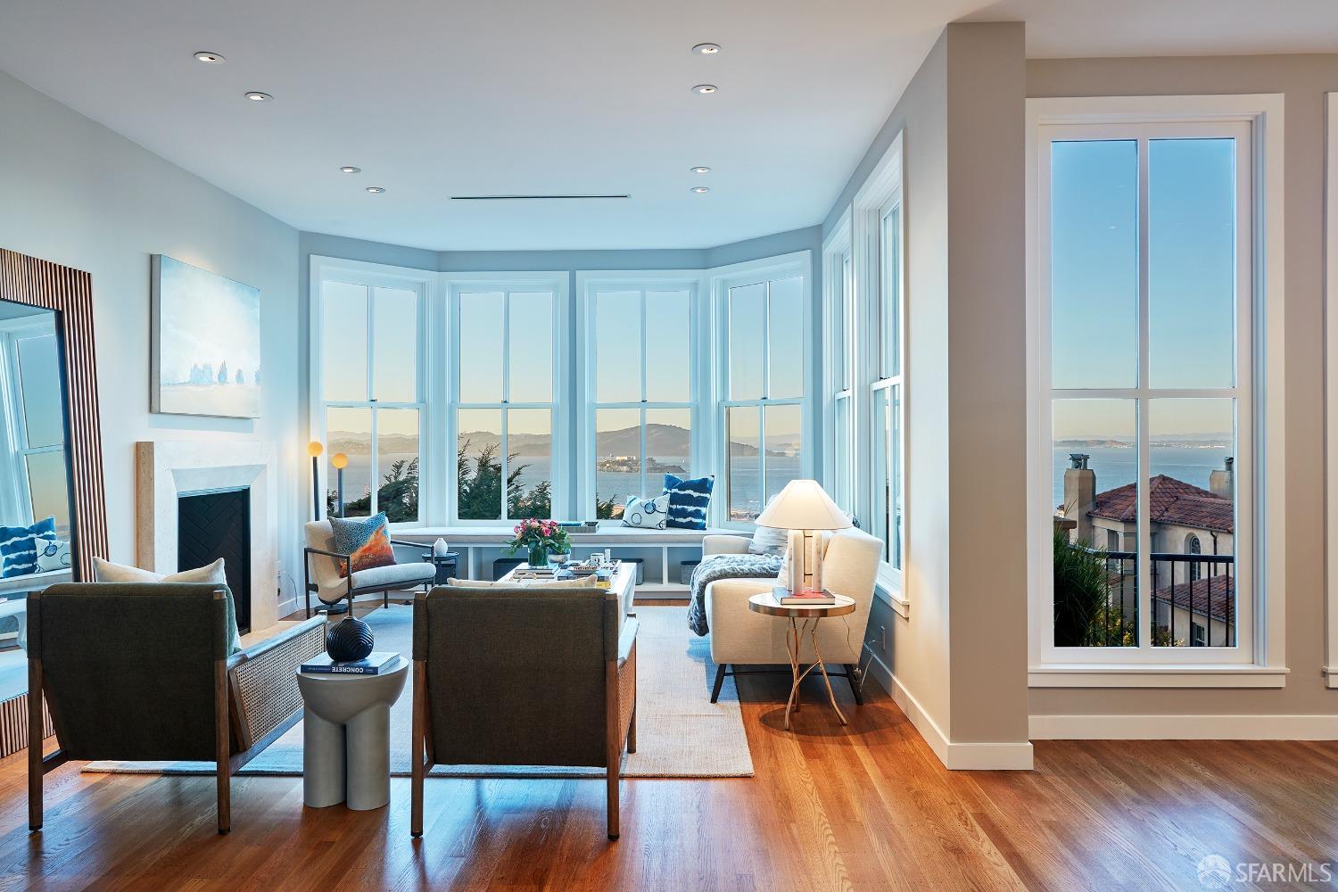 a living room with fireplace furniture and a large window