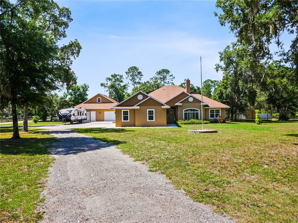 a front view of house with yard and green space