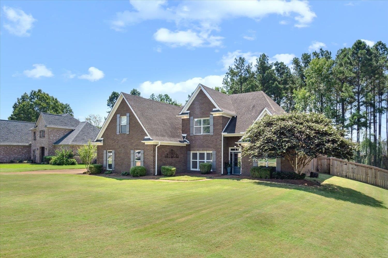 a front view of house with yard and green space