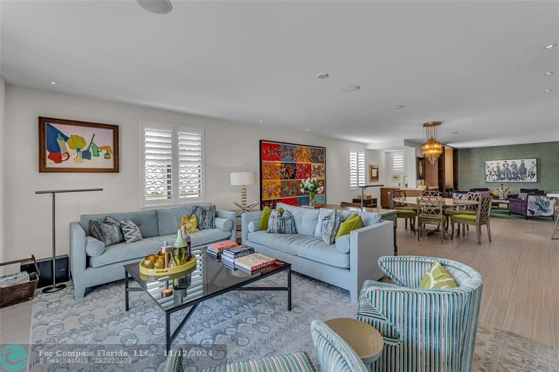 a living room with furniture a rug and a window