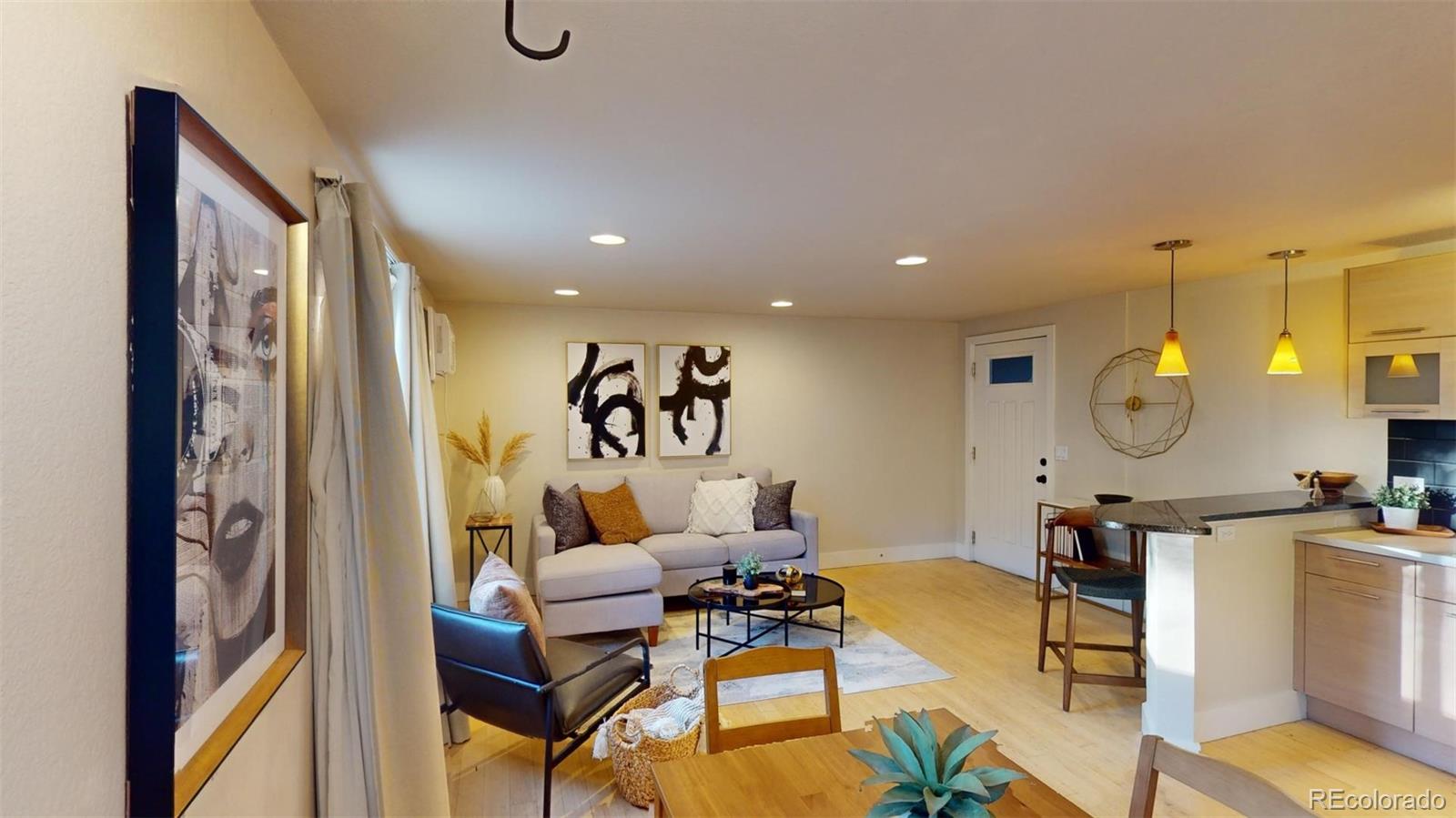 a living room with furniture and wooden floor