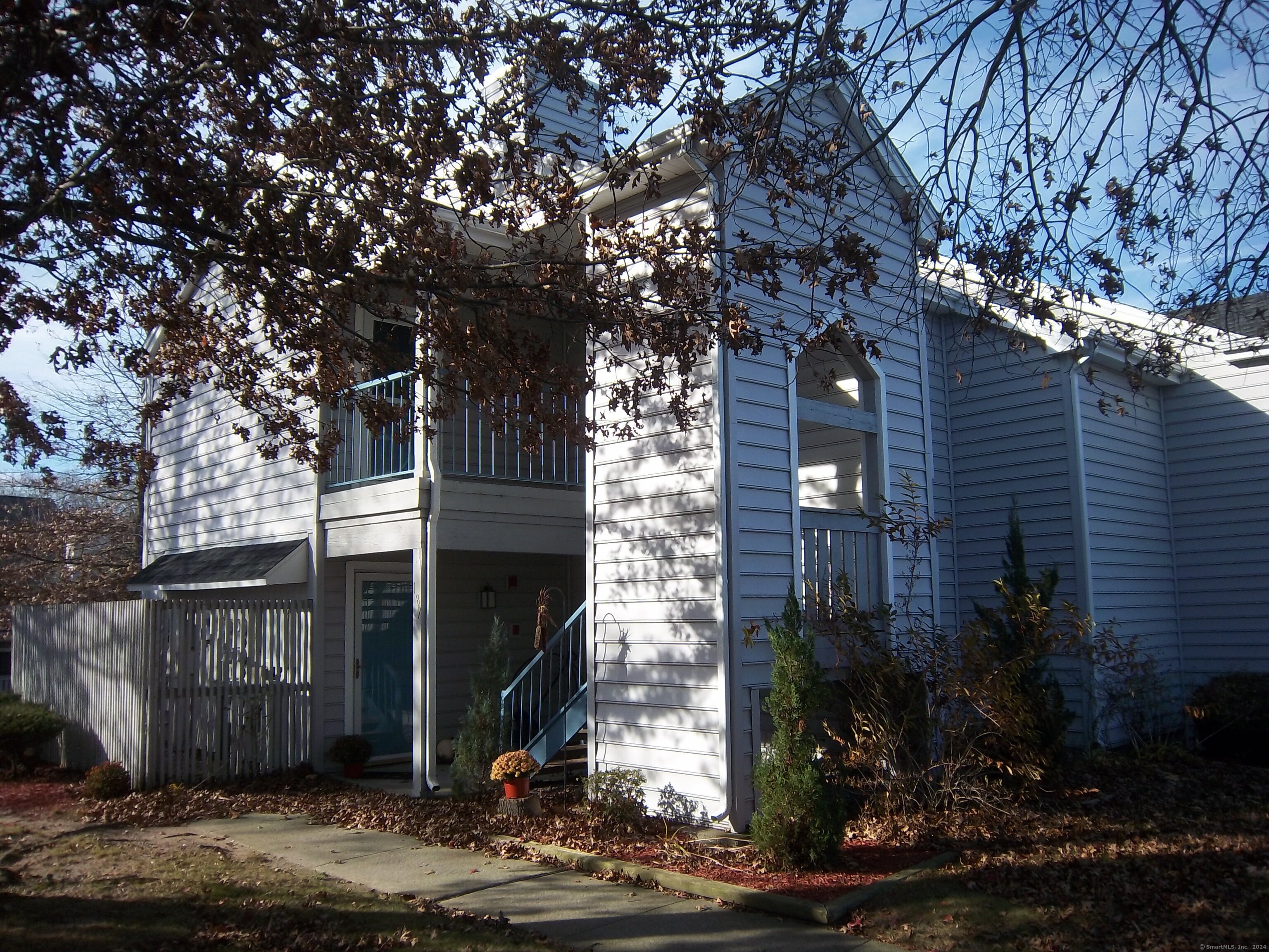 a front view of a house with plants