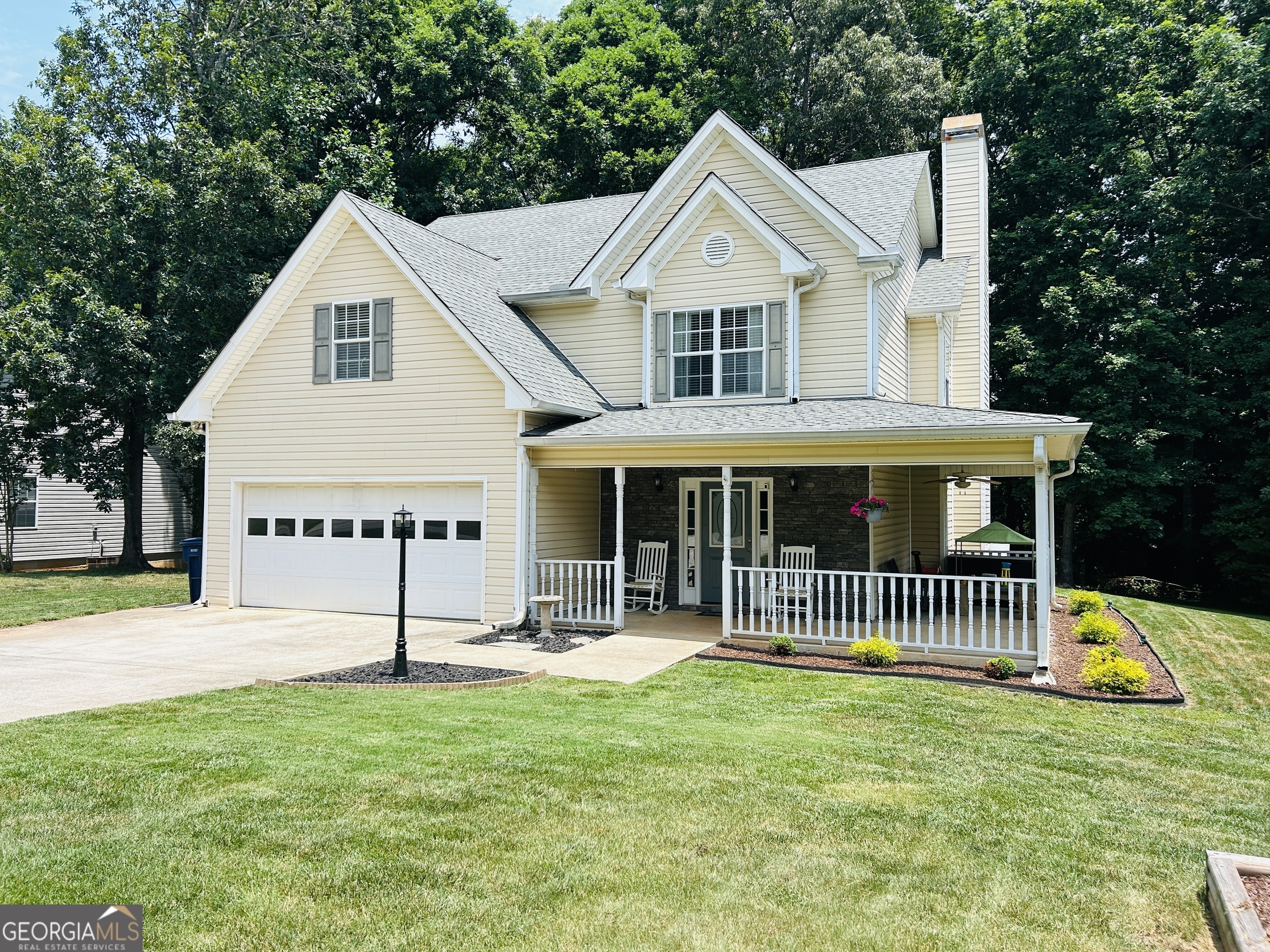 a front view of a house with a garden and deck