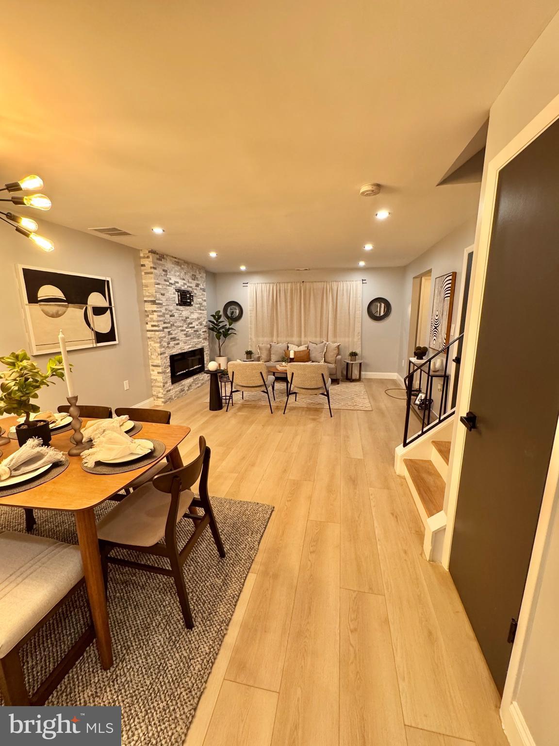 a living room with dining room and wooden floor