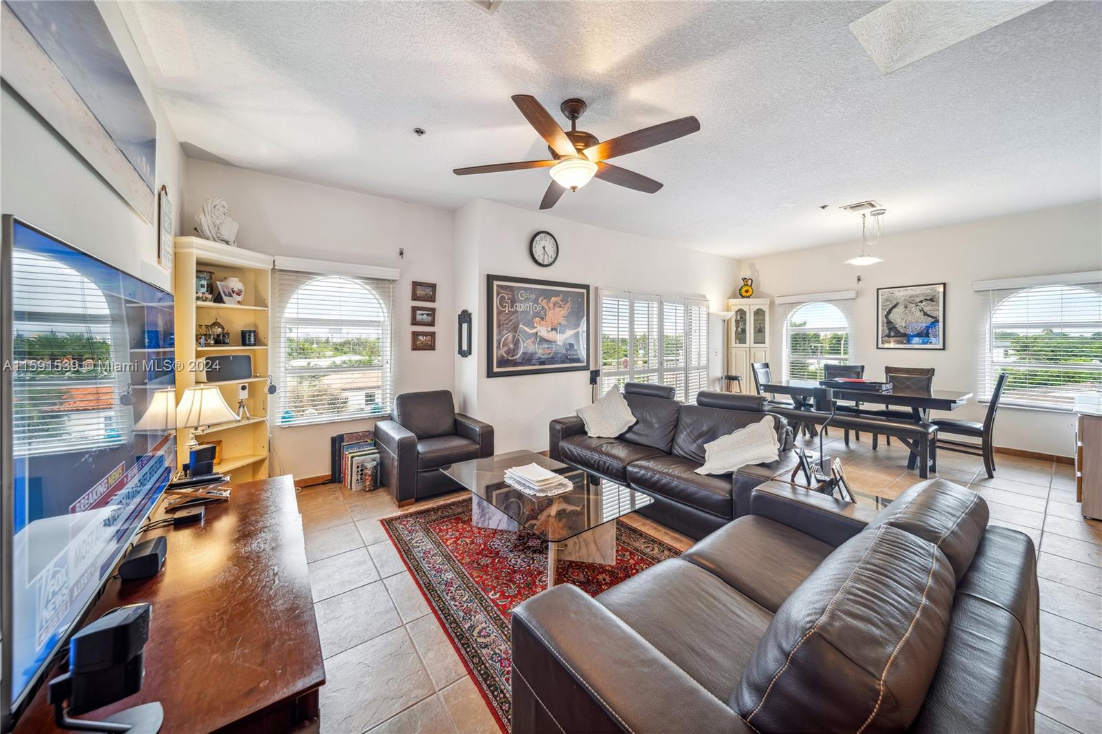 a living room with furniture ceiling fan and a rug