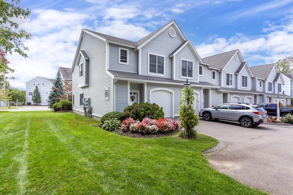 a view of a house with a garden and pathway