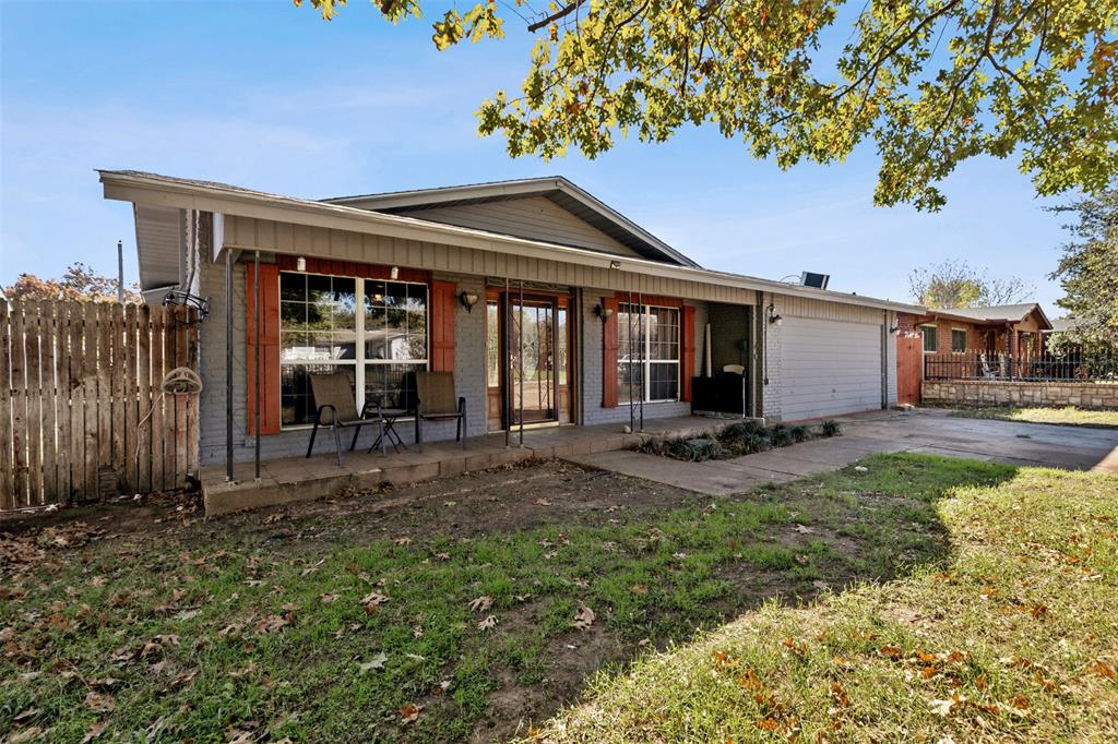 a backyard of a house with yard and outdoor seating