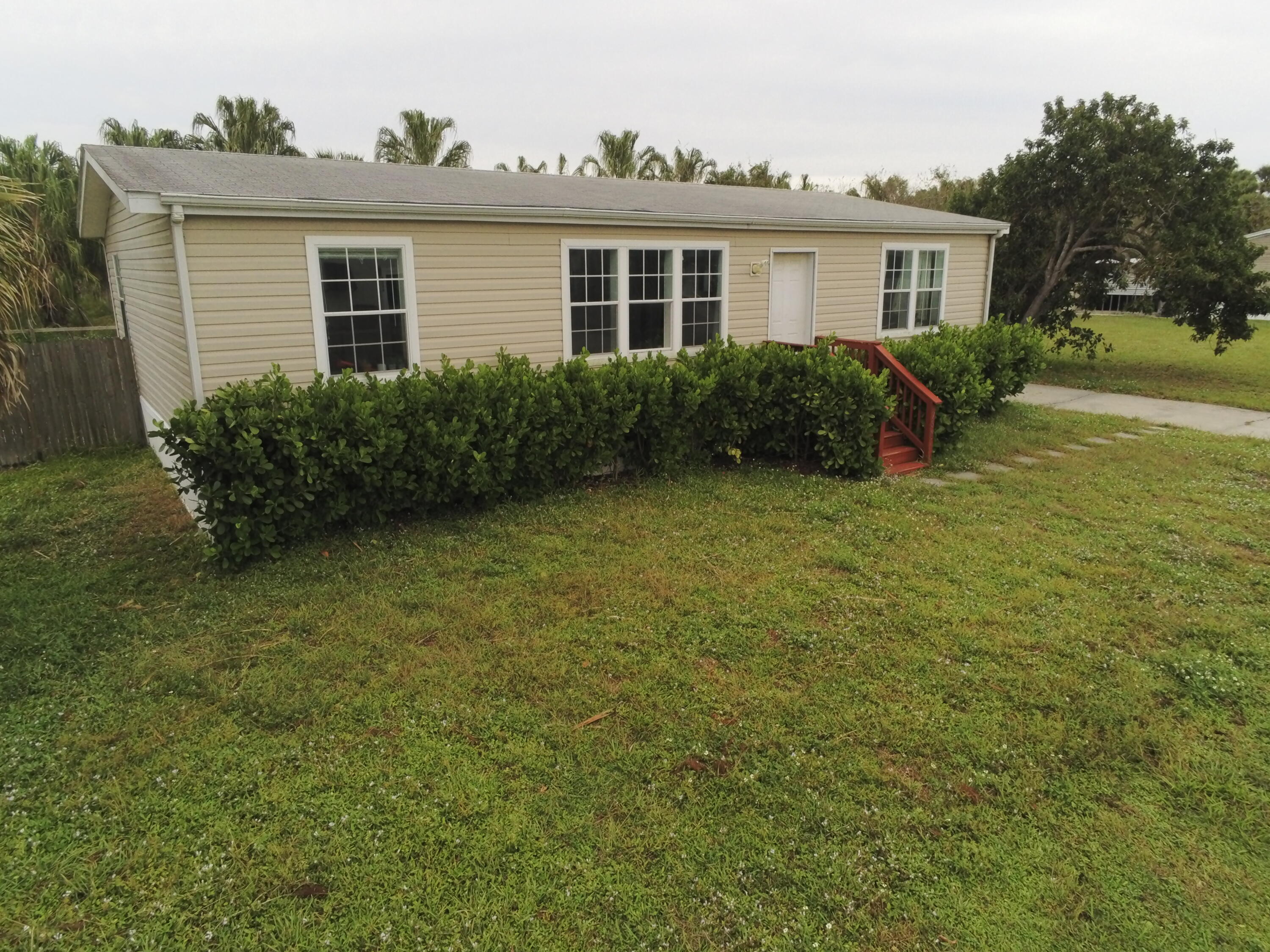 a view of backyard of house with green space