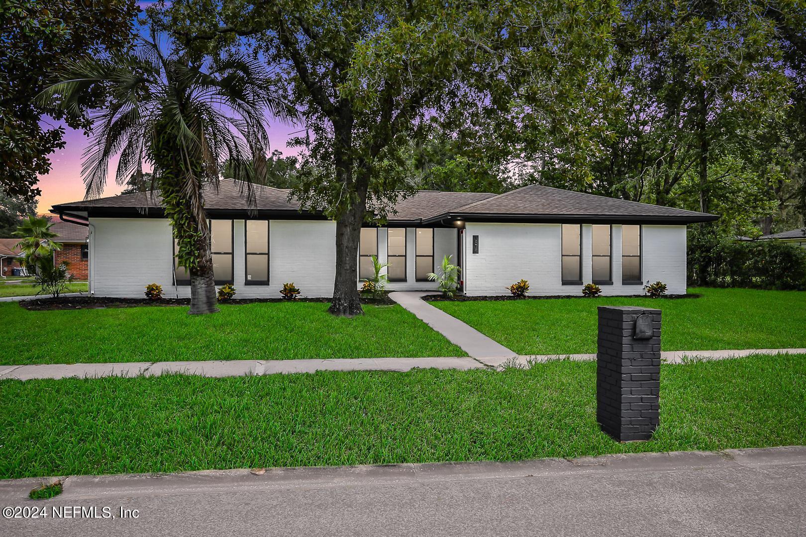 a front view of house with yard and green space