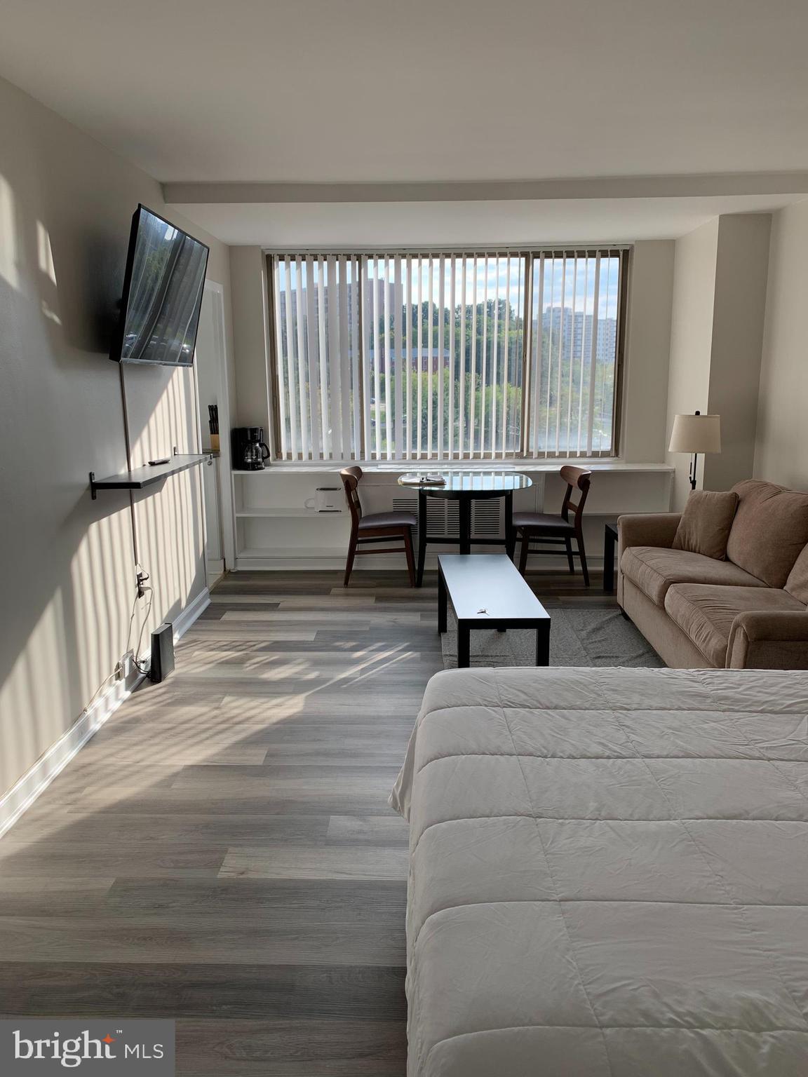 a living room with furniture and a floor to ceiling window