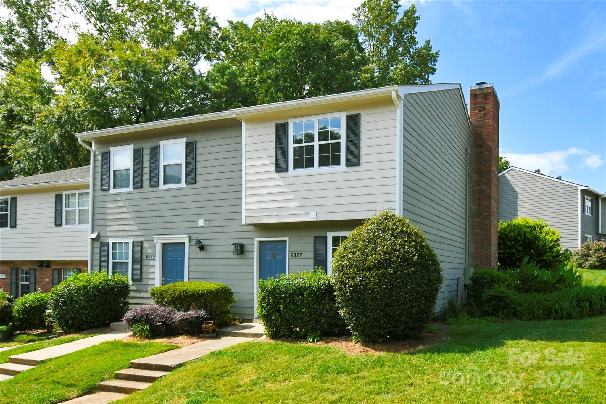 a view of a house with a yard and plants