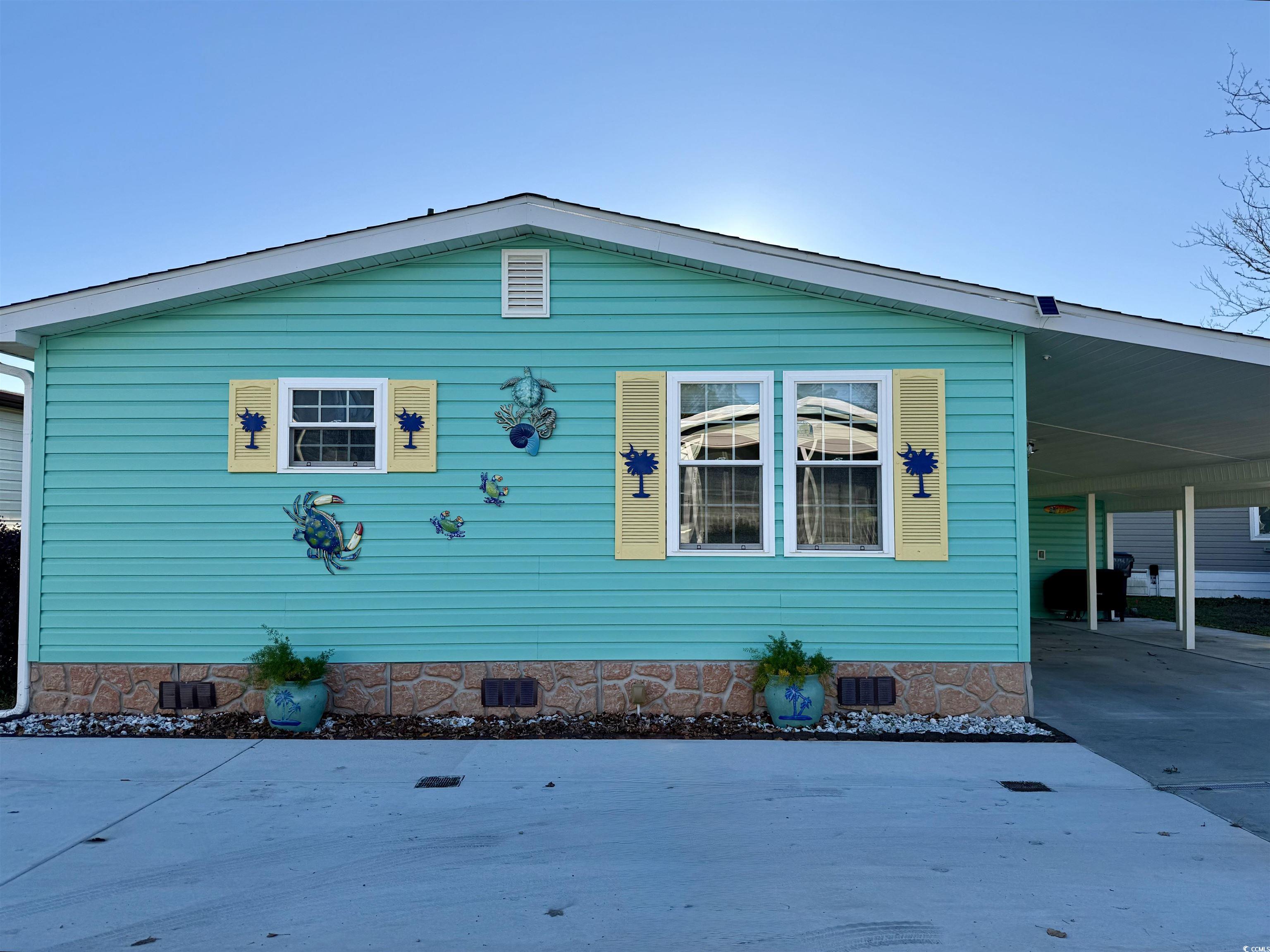 View of side of property with a carport