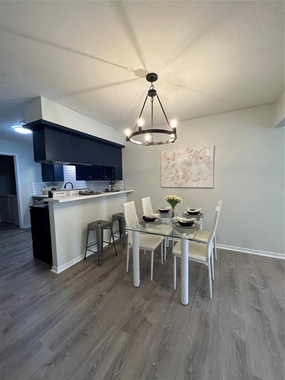 a view of a dining room with furniture wooden floor and chandelier