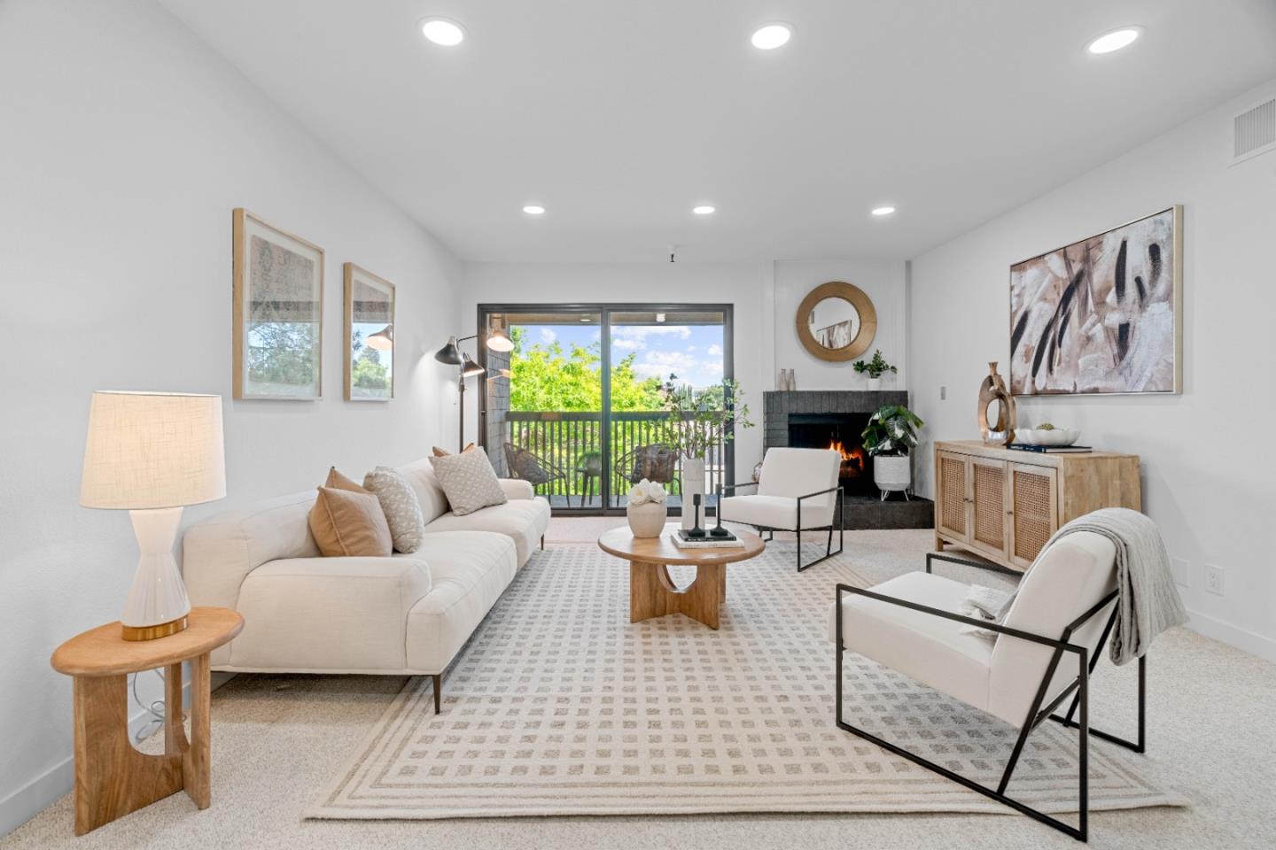 a living room with furniture a large window and a table