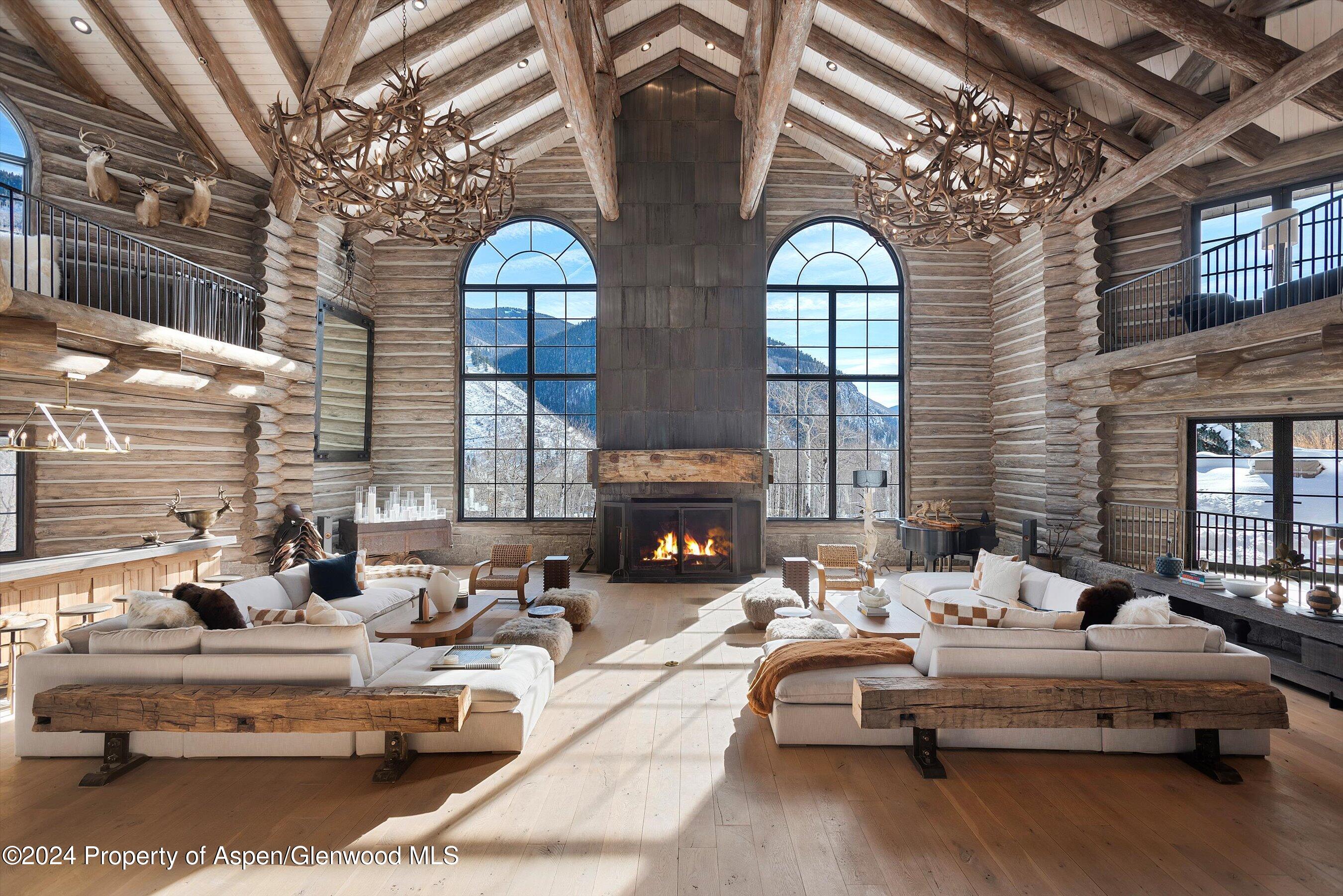 a living room with patio furniture and fireplace