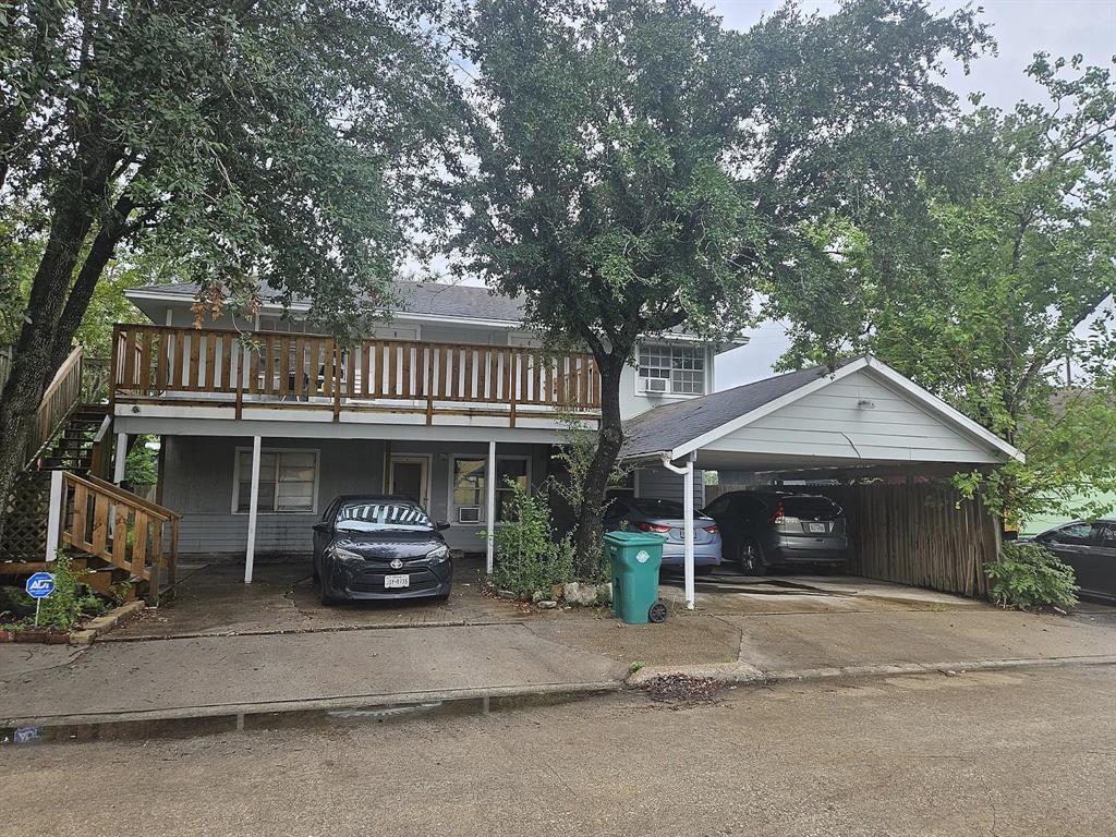 a front view of a house with a garden and parking