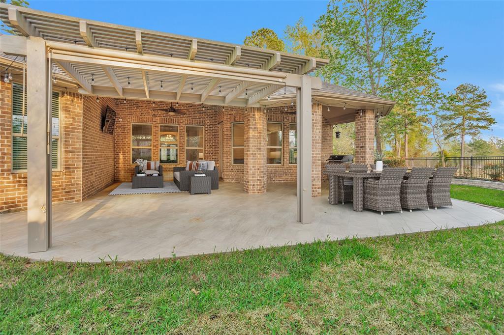 Great backyard in Bonterra 55+ ACTIVE LIFESTYLE LIVING....Texas Entertainment option includes Sunroom, extended covered patio with Summer Kitchen & the outdoor mounted TV stays. All the makings for an amazing entertainment space or that morning coffee/evening nightcap. (Virtually Staged)