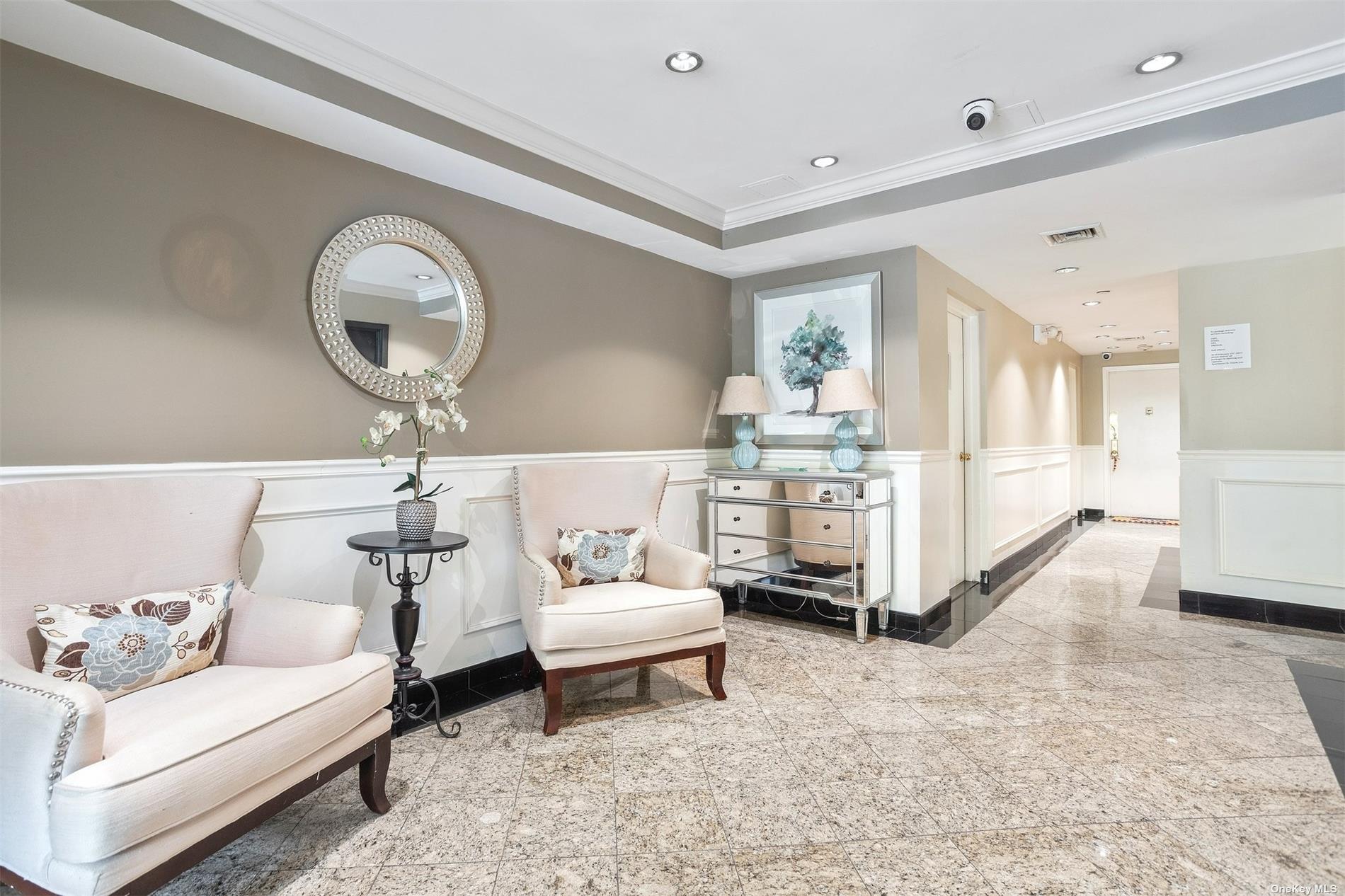 a living room with furniture and a mirror