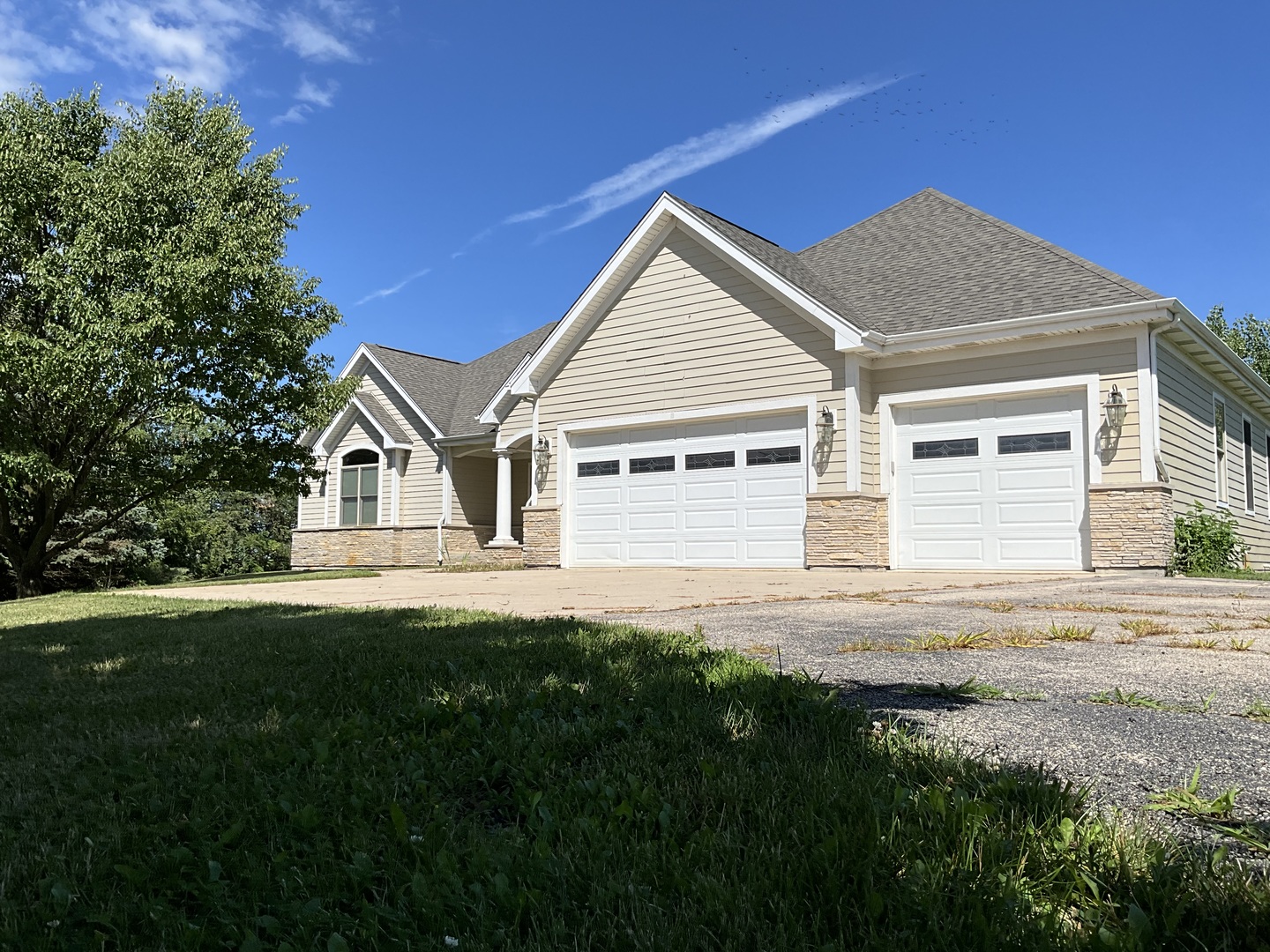 a front view of a house with a garden