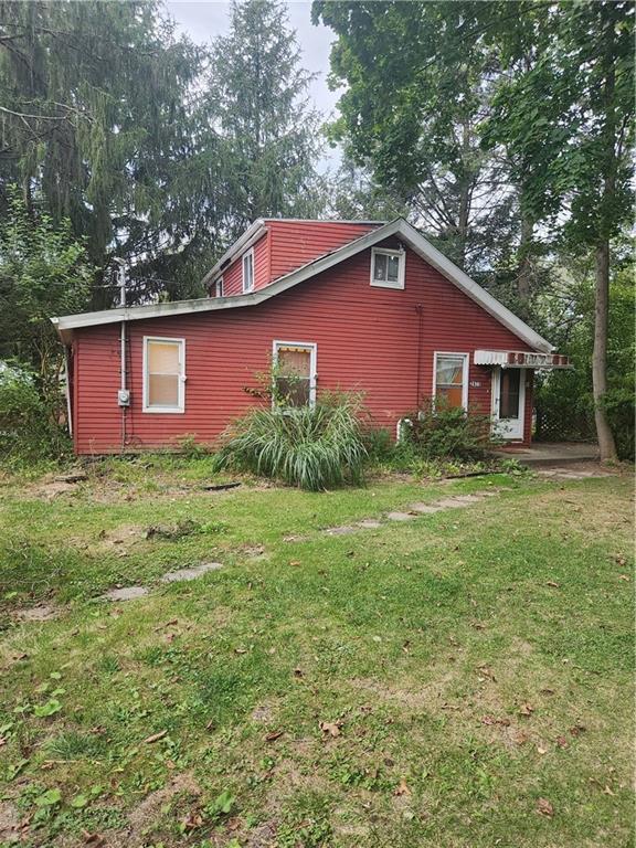 a front view of house with yard and trees