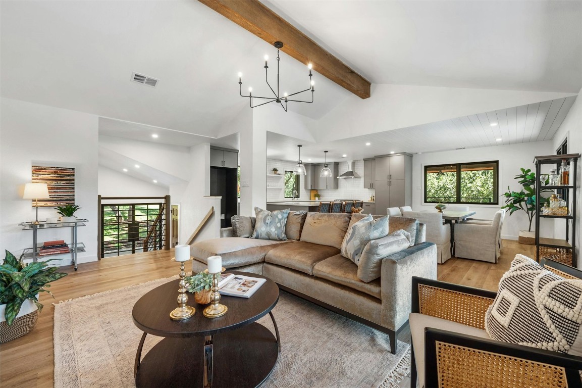 a living room with furniture kitchen view and a dining table