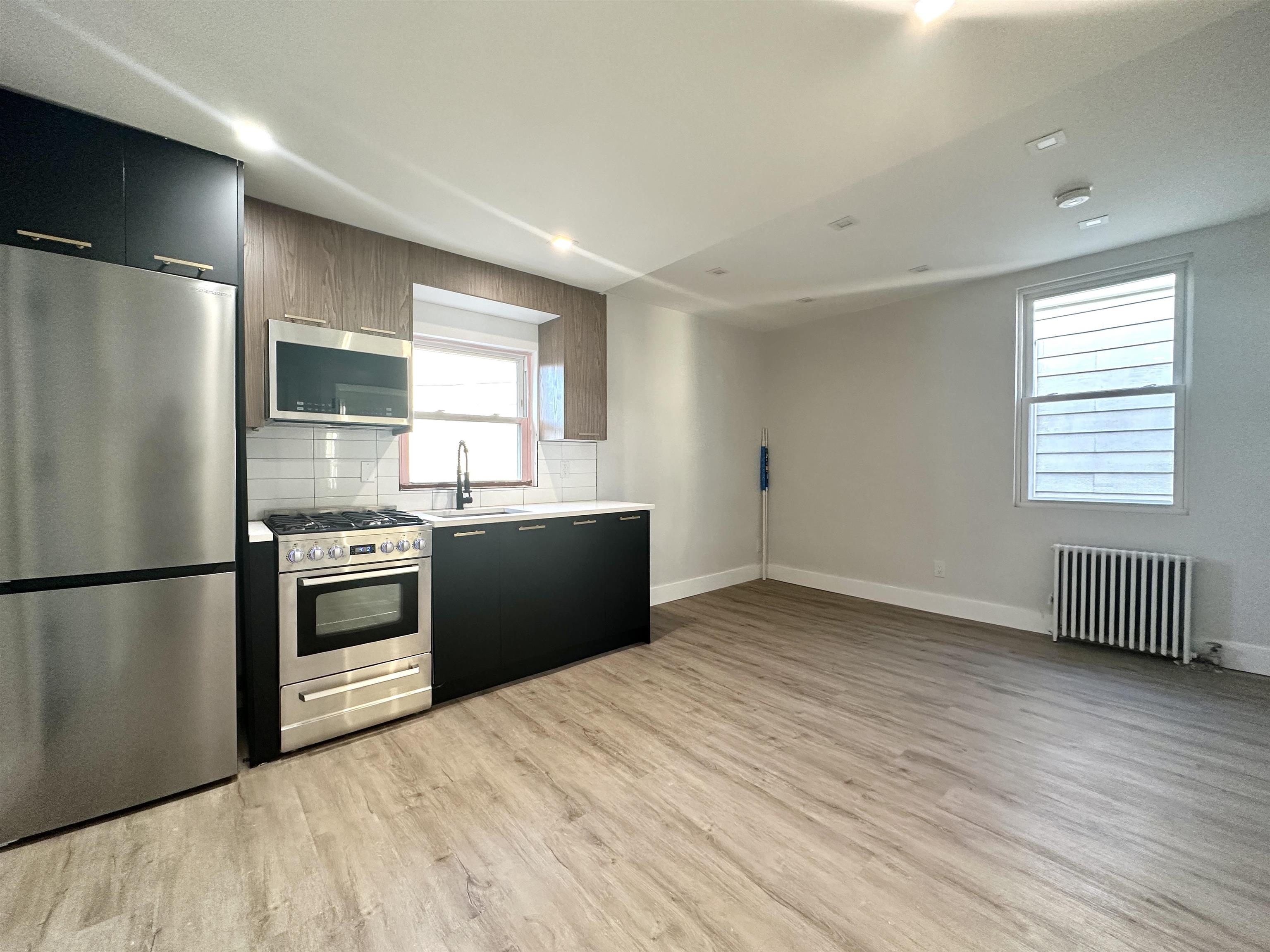 a kitchen with a refrigerator and a sink