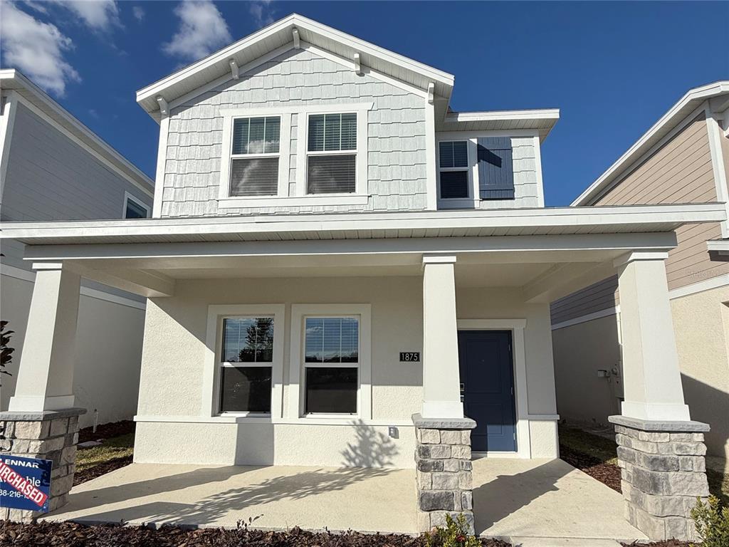 a front view of a house with glass windows and couches