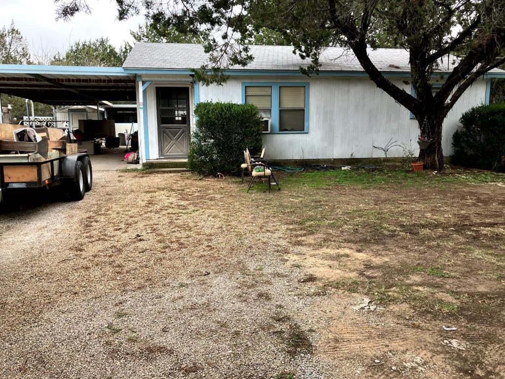 a view of a house with backyard and sitting area