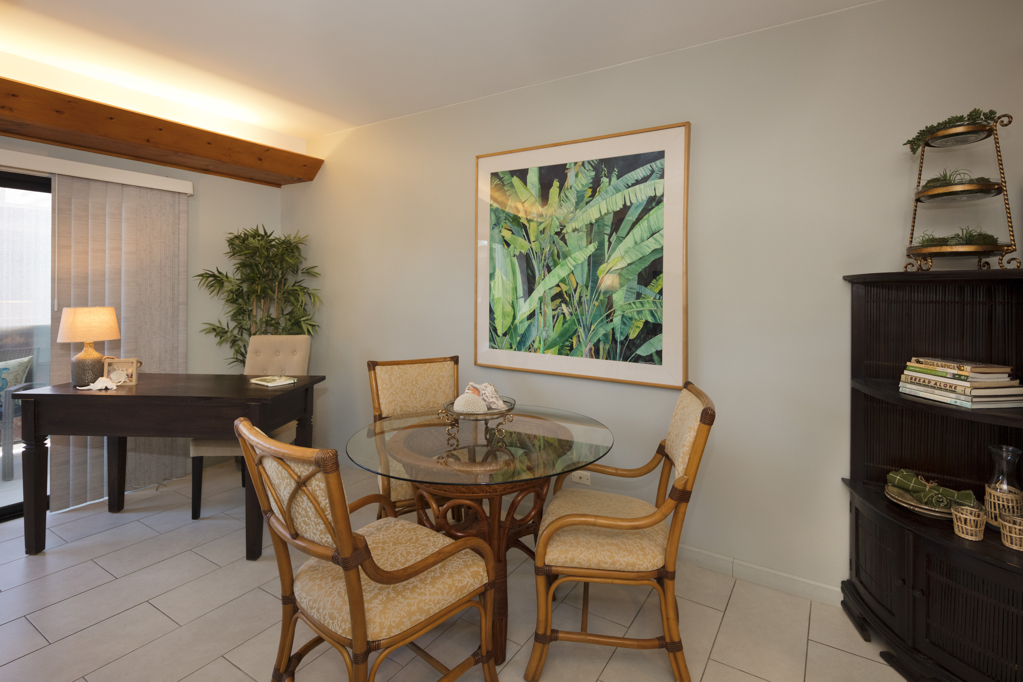 a dining room with furniture and a potted plant