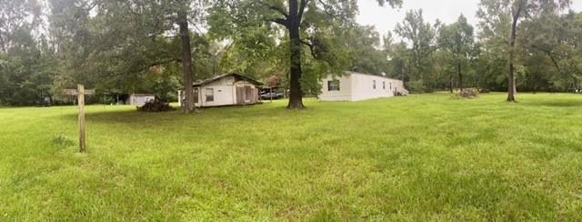 a view of a house with a yard and tree s