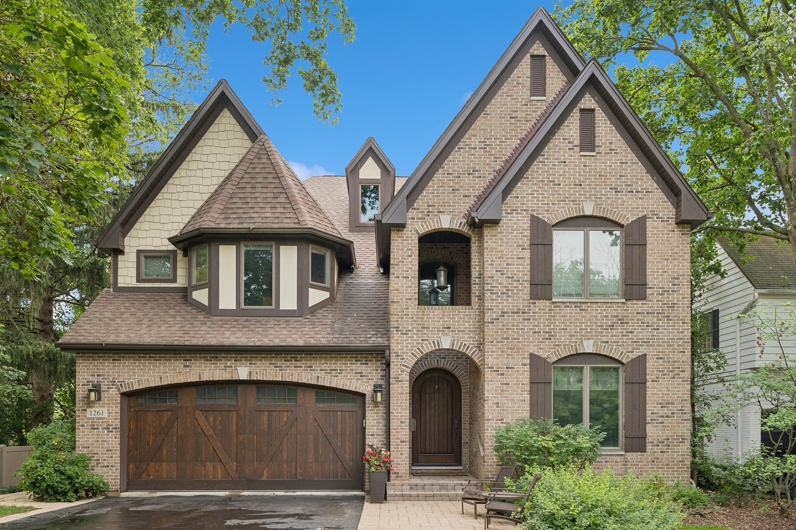 a view of a brick house with large windows