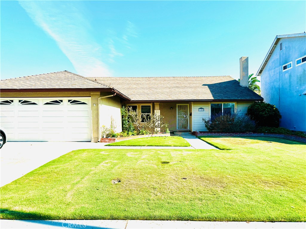 a view of a house with pool and a yard