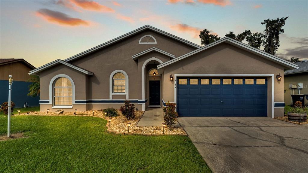 a front view of a house with a yard and garage