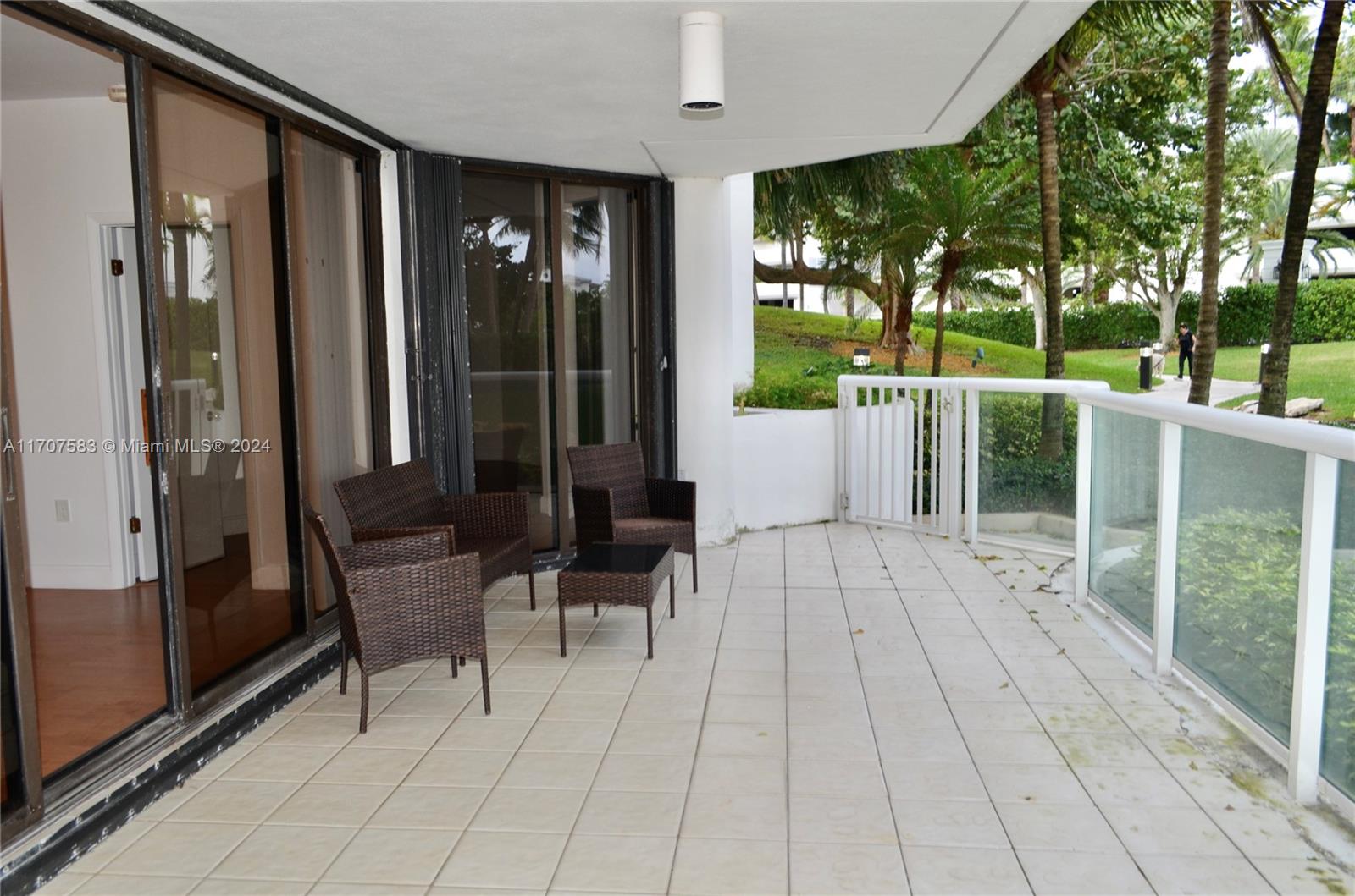 a view of balcony with furniture and garden