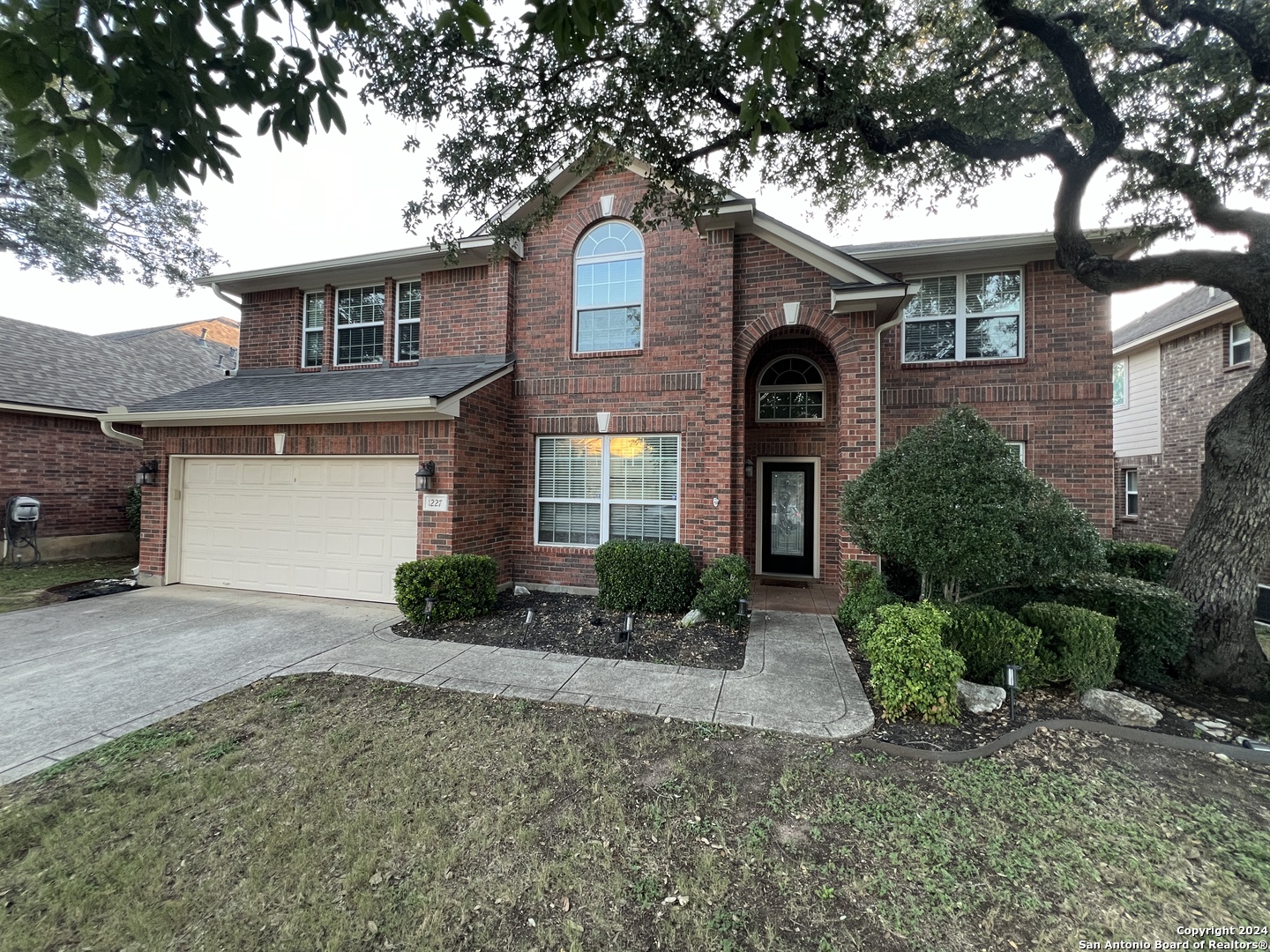 a front view of a house with a yard and garage