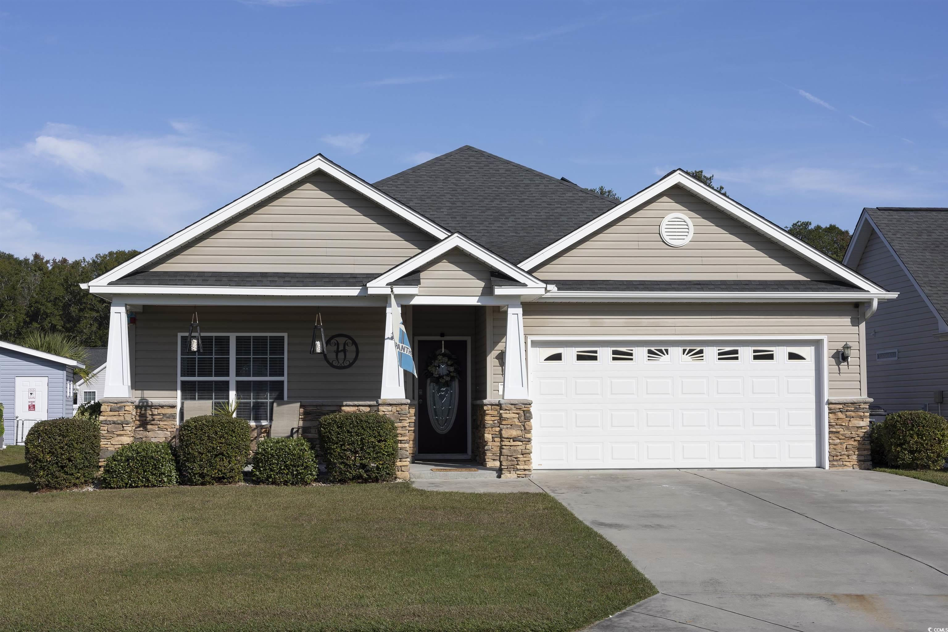 Craftsman-style home featuring a garage and a fron