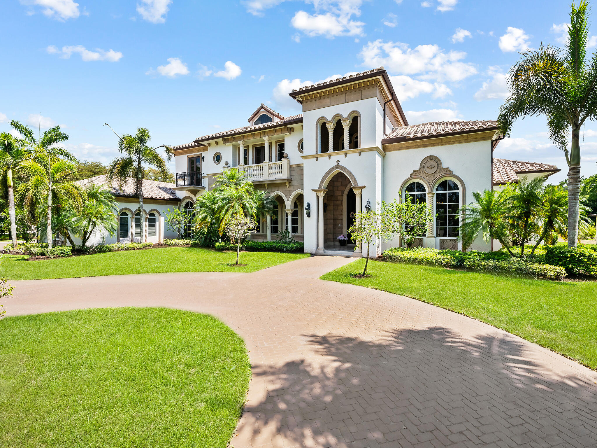 a front view of a house with a garden and yard