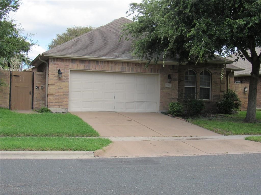 a front view of a house with a garden and garage