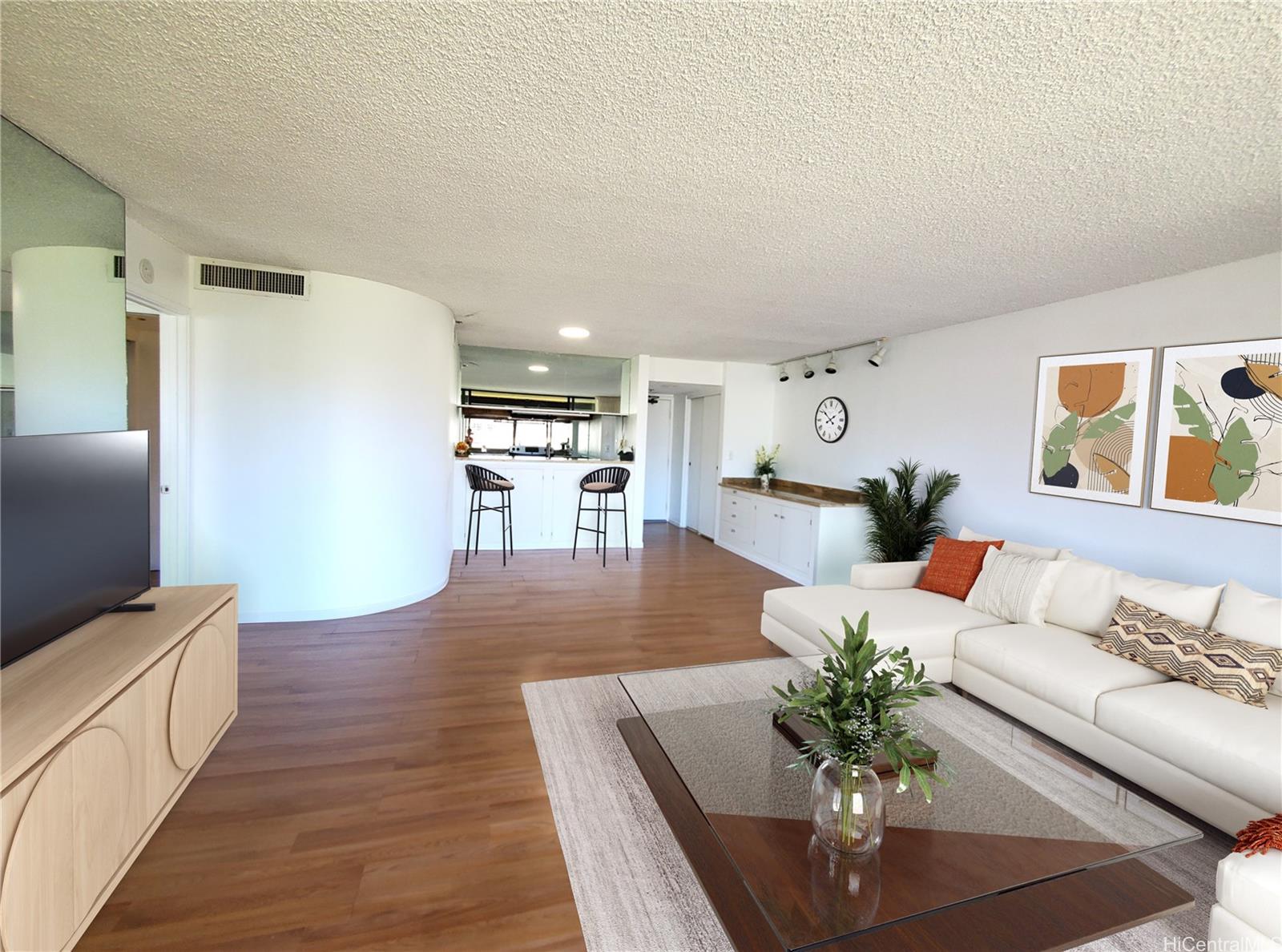 a living room with furniture and wooden floor