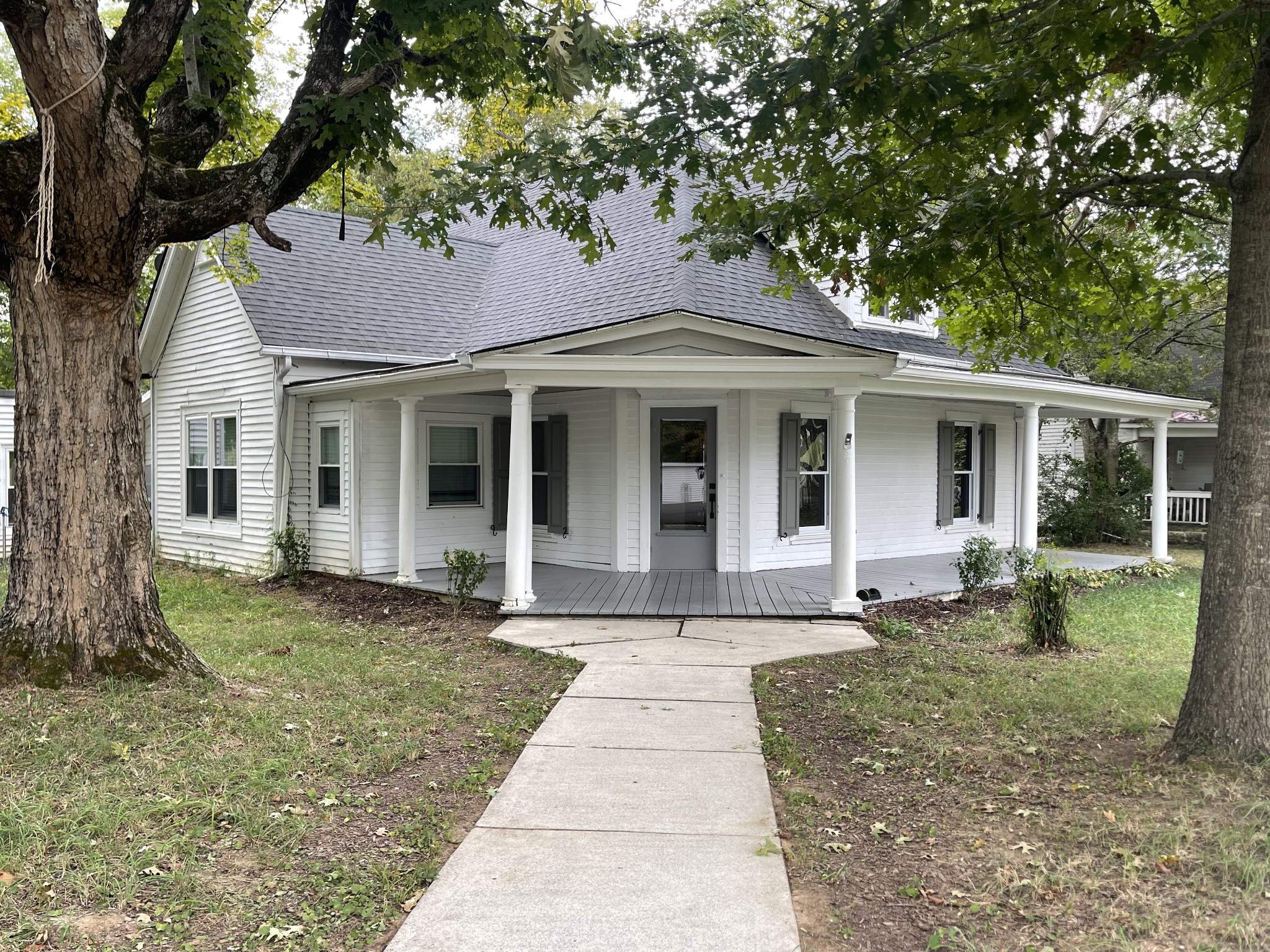 a front view of a house with a garden